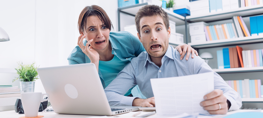 Stressed Couple Checking scary expensive Bills