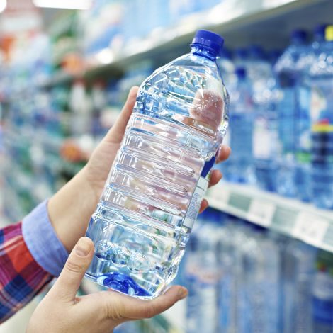 Challenge Woman with bottle drinking water in shop