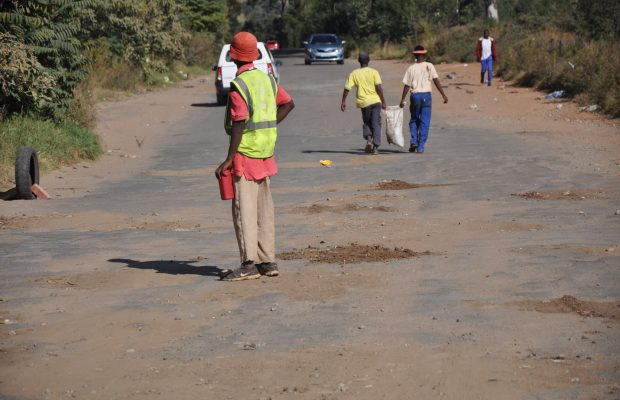 Pics: Group of South Africans are fixing potholes in their community!