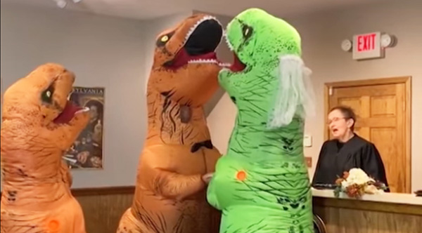 A couple getting married in Dinosaur Costumes is the best thing you will see today!