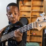 Likhona Ngomani practices bass guitar.