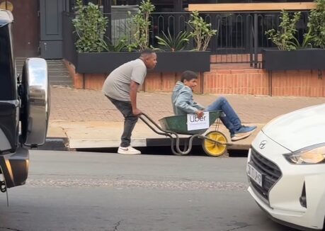 Themba Robin Pushes Through the Petrol Price Hikes with Wheelbarrow “Uber”